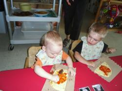 Toddlers making pizzas